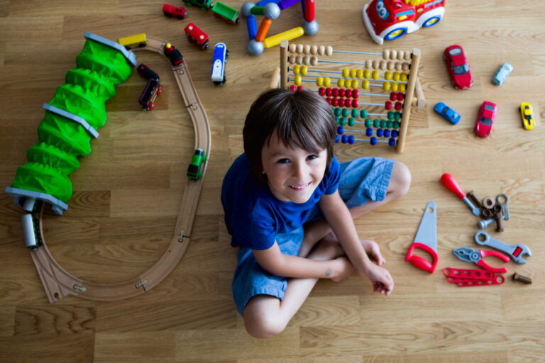 Young boy playing with toys in room